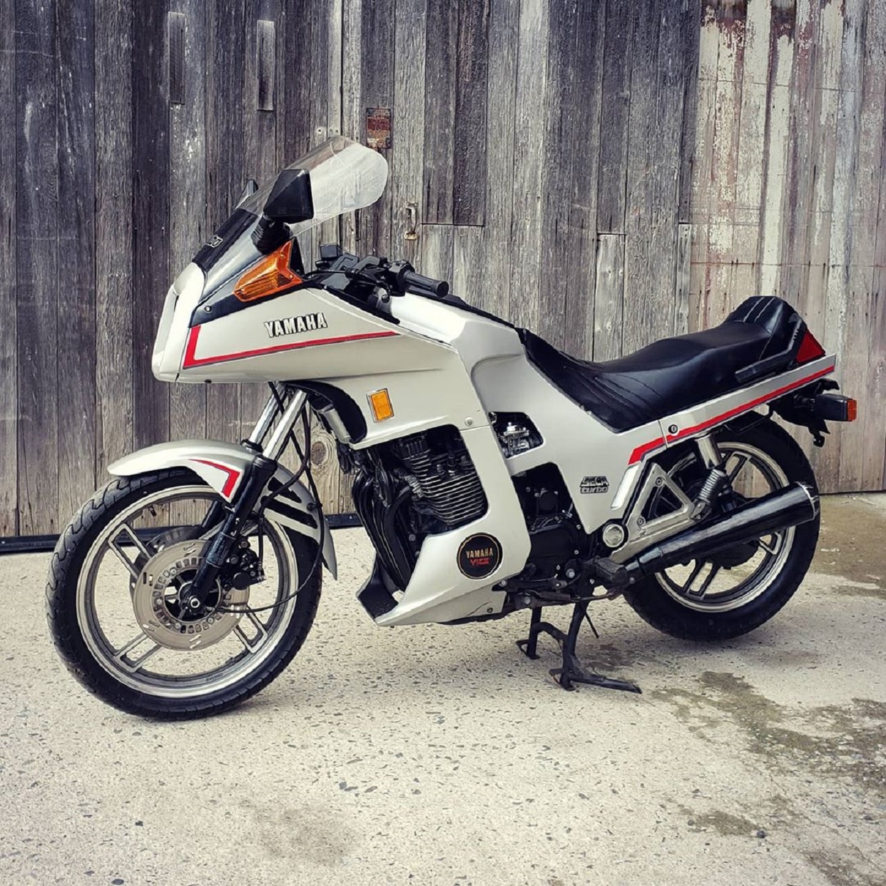 White 1983 Yamaha XJ650 Seca Turbo in front of a fence
