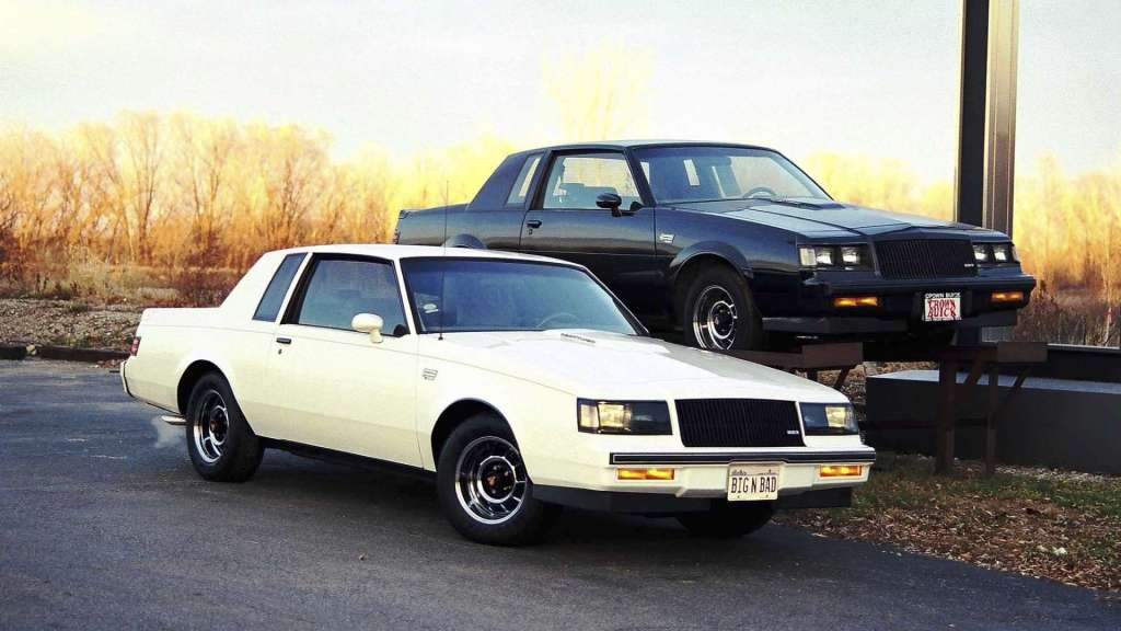 A white Buick Regal T-Type and a black Buick Grand National sit beside each other.