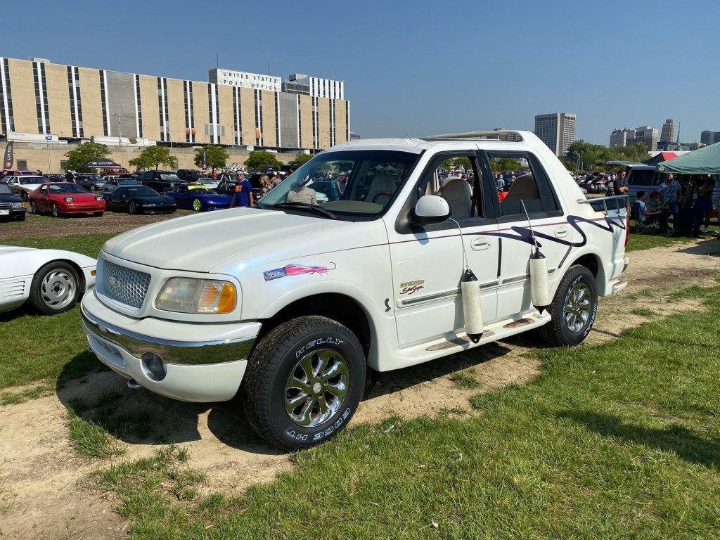 A white nautical themed Ford Expedition parked at a car show.