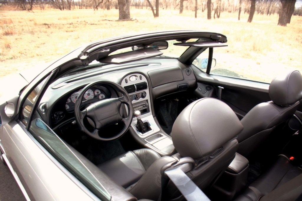2000 Qvale Mangusta with the roof down, showing the black leather interior