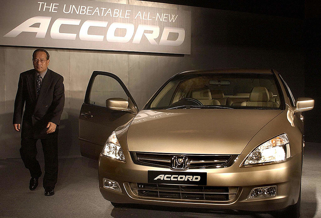 President and Chief Executive Officer (CEO) of Honda Siel Cars India Ltd. H Yamada walk pass the all new Honda Accord car during its launch in New Delhi, 10 June 2003