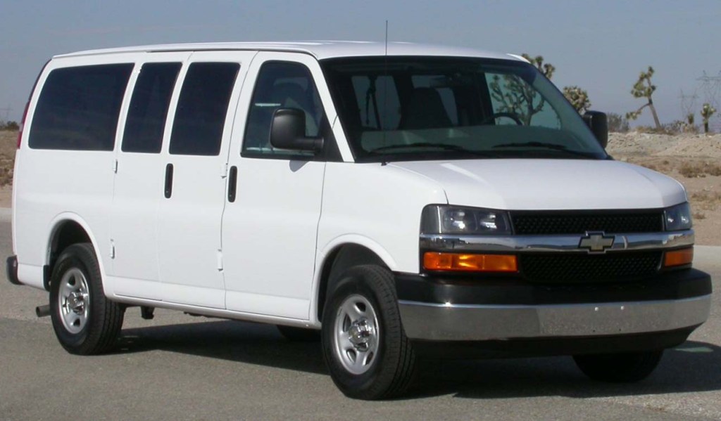 A white 2005 Chevrolet Express full-size passenger van