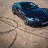Dark blue 2007 Aston Martin V8 Vantage Valiant restomod on the track