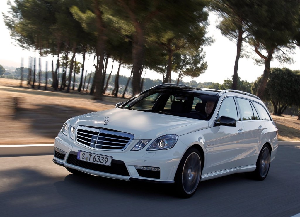 White 2012 Mercedes-Benz E63 AMG Wagon driving on a shadowy road