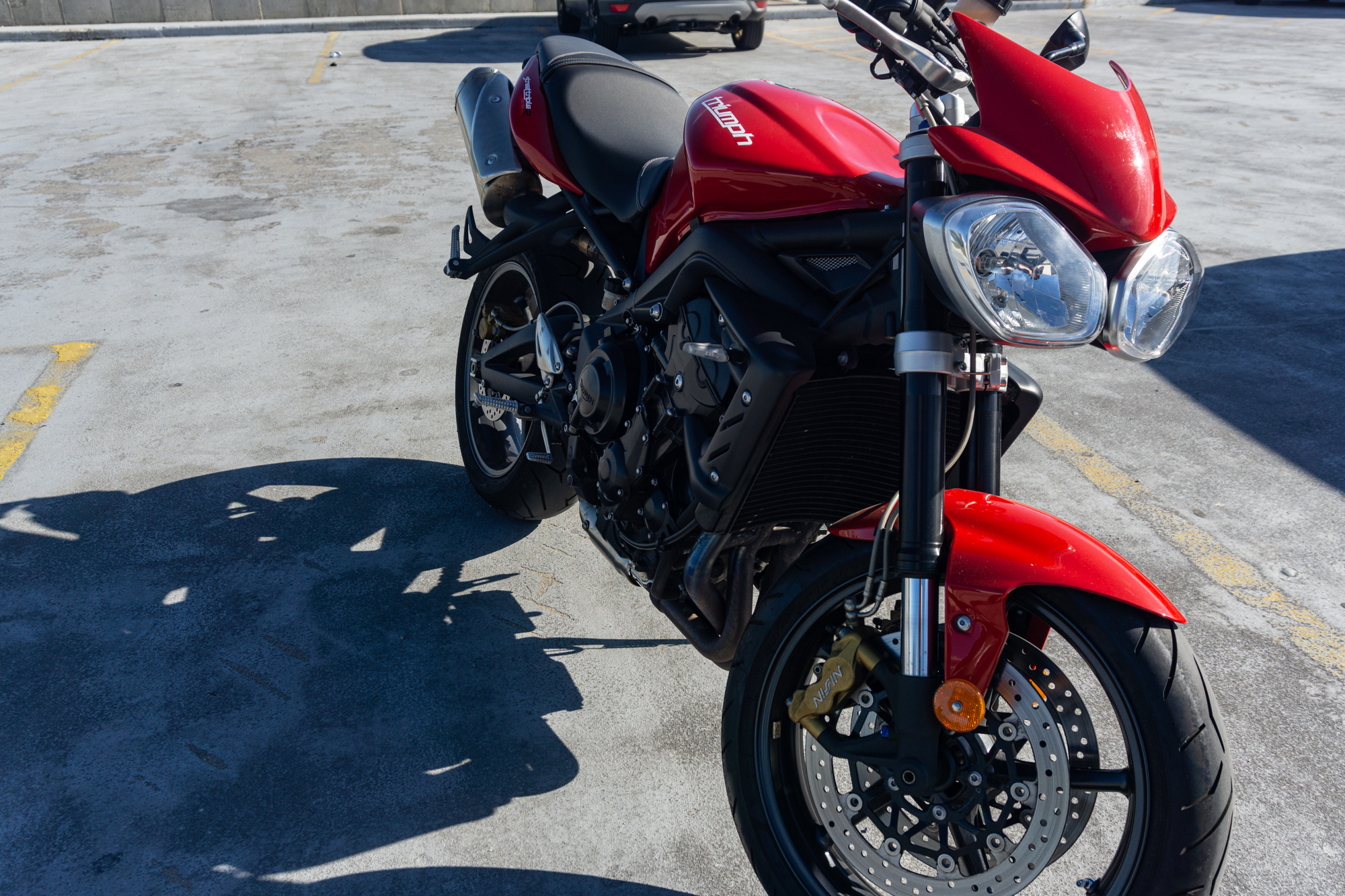 Red 2012 Triumph Street Triple R from the rider's right side