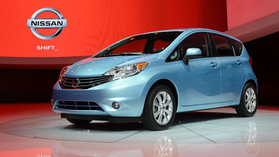 The a blue Nissan Versa on display at an auto show