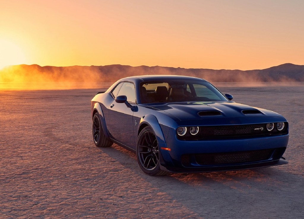 Blue 2019 Dodge Challenger SRT Hellcat in the desert, with the setting sun in the background
