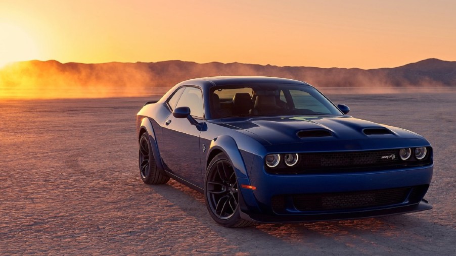 Blue 2019 Dodge Challenger SRT Hellcat in the desert, with the setting sun in the background