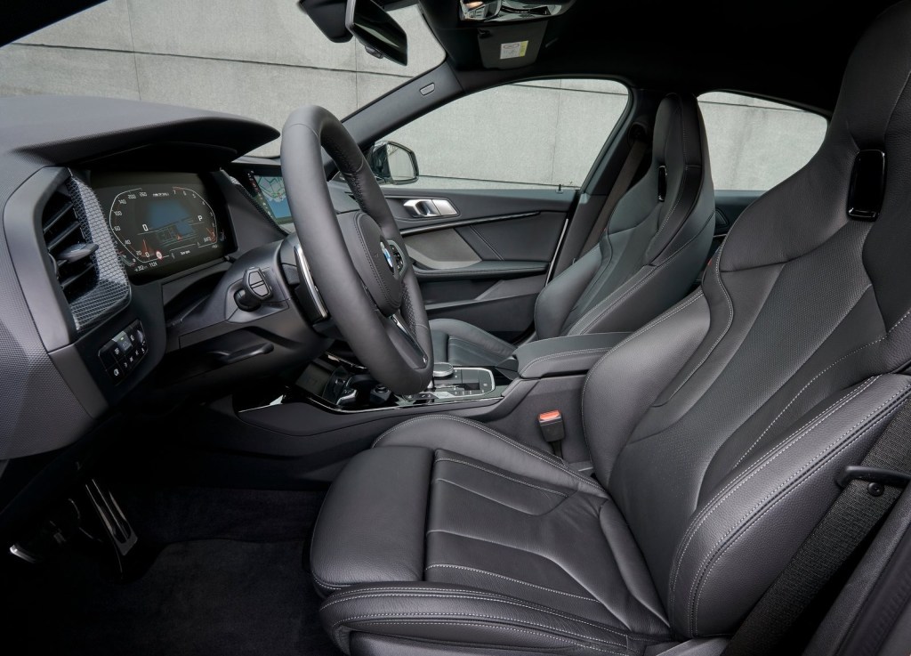 Front seats, driver gauges, and center console of the 2020 BMW M235i Gran Coupe, in black leather