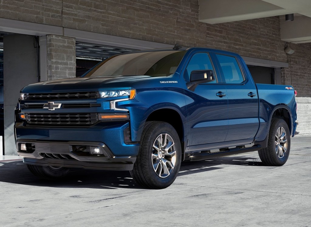 Blue 2020 Chevrolet Silverado 1500 RST Crew Cab 4x4 in front of a storage garage