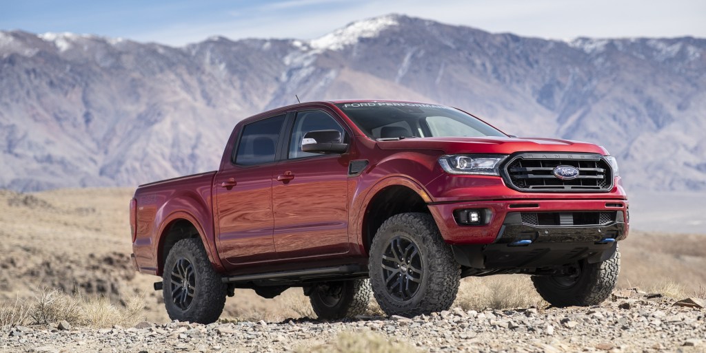 Red 2020 Ford Ranger pickup truck with Ford Performance Level 2 Package in the desert in front of a mountain range