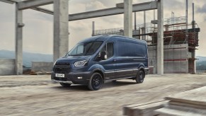 Blue 2020 Ford Transit Trail van driving through a construction site