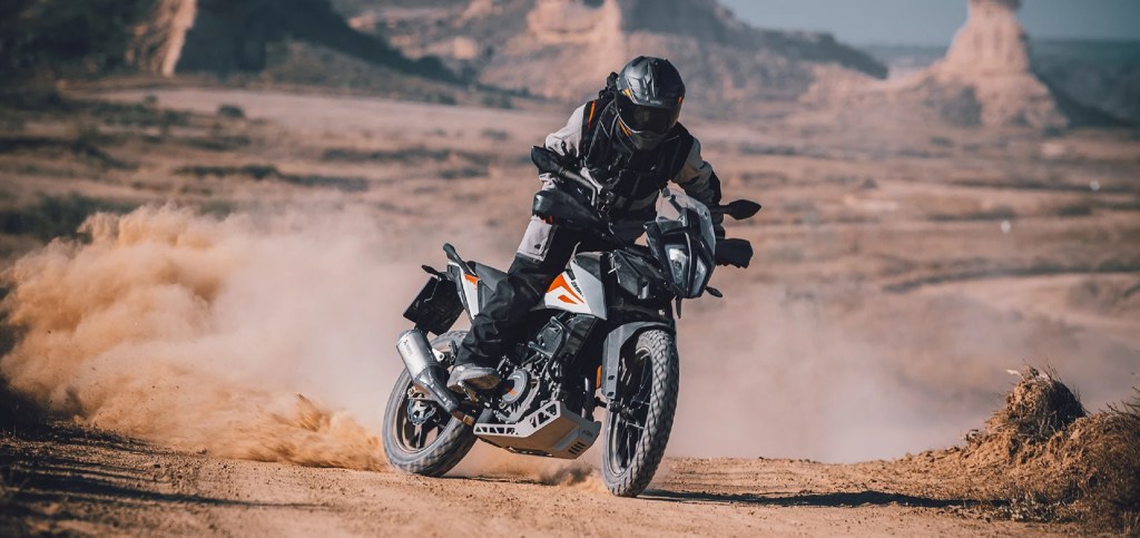 2020 KTM 390 Adventure motorcycle sliding through the desert