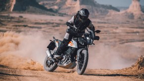 2020 KTM 390 Adventure motorcycle sliding through the desert
