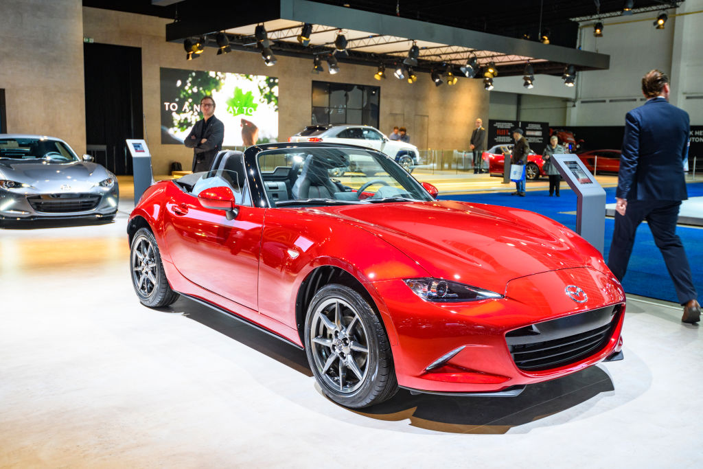 A red Mazda MX-5 Miata on display at an auto show