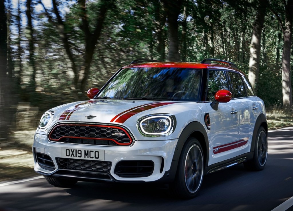 White and red-striped 2020 Mini Clubman JCW driving down a forest road