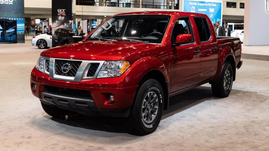 A red 2020 Nissan Frontier on display at a car show