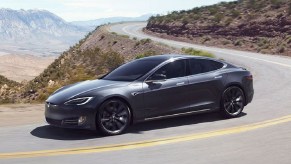 Metallic gray 2020 Tesla Model S Long Range Plus driving around a mountain road