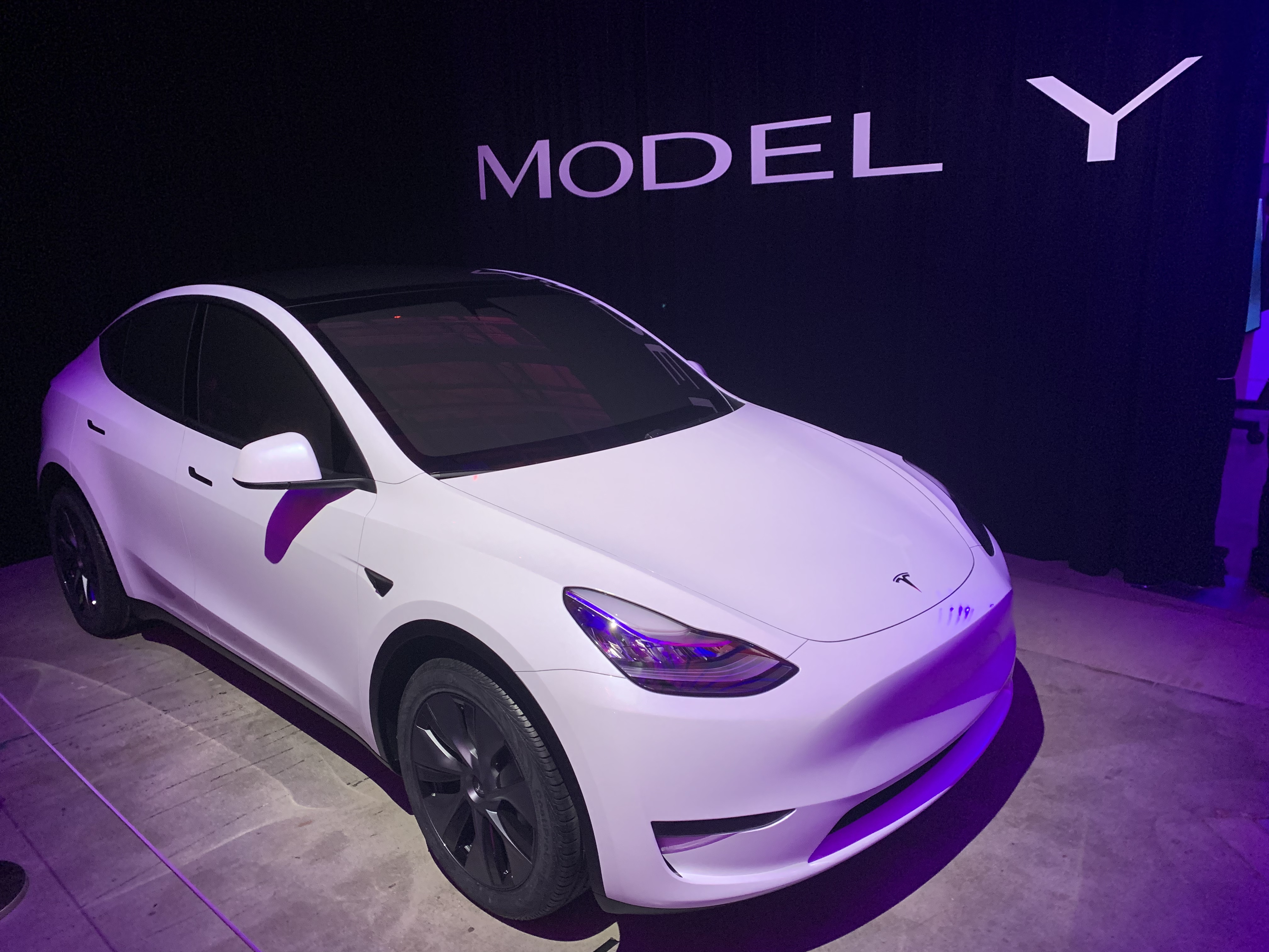A white Model Y sits in a display
