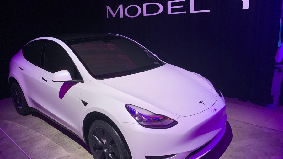 A white Model Y sits in a display