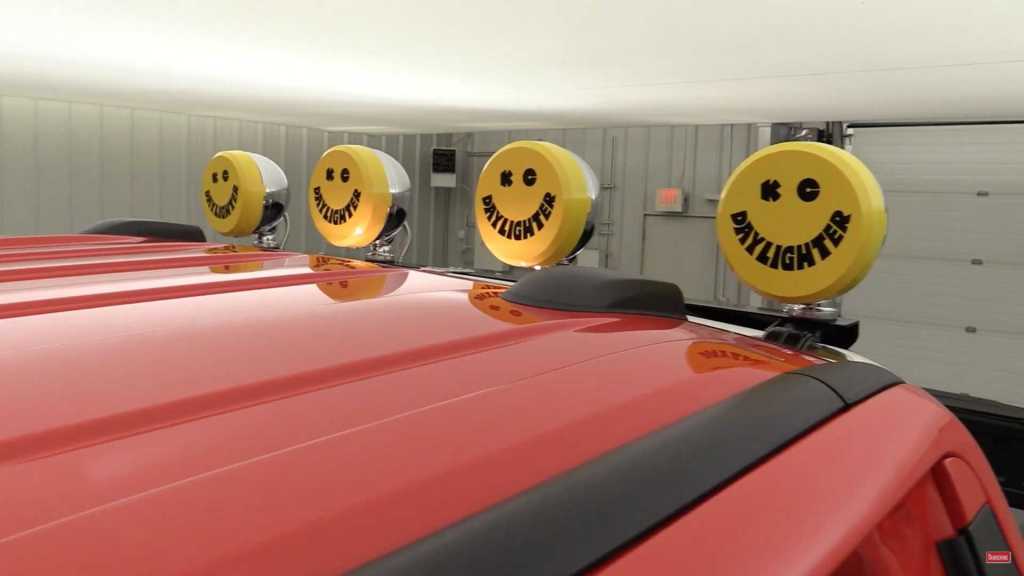 close up of Daylighter lamps on chrome roll bar with yellow happy face covers on them