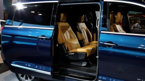 A blue 2021 Chrysler Pacifica on display at an auto show