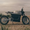 Brushed-aluminum 2021 Tarform Luna electric motorcycle on a beach
