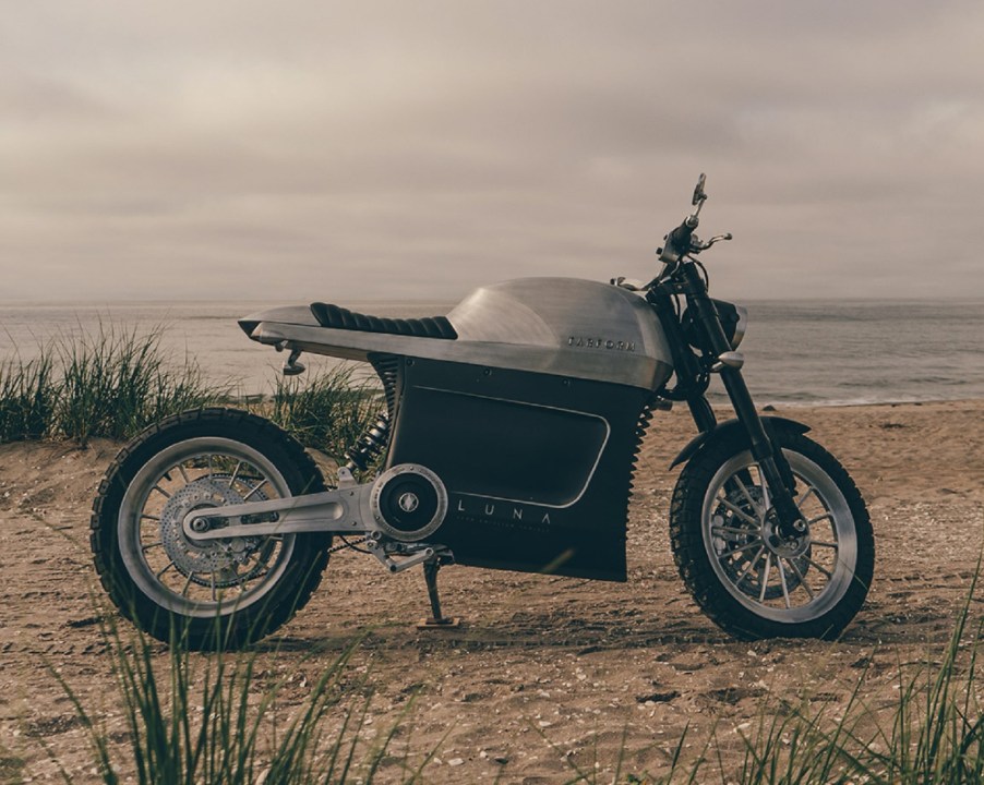 Brushed-aluminum 2021 Tarform Luna electric motorcycle on a beach