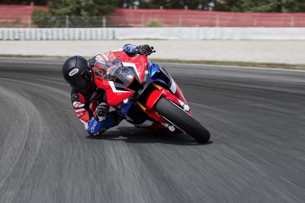 the all-new Honda Fireblade leaning into a tight corner at high speed