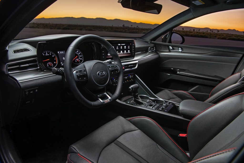 red trimmed leather interior of a 2021 Kia K5. The new k5 sedan is praised for its quiet cabin. 