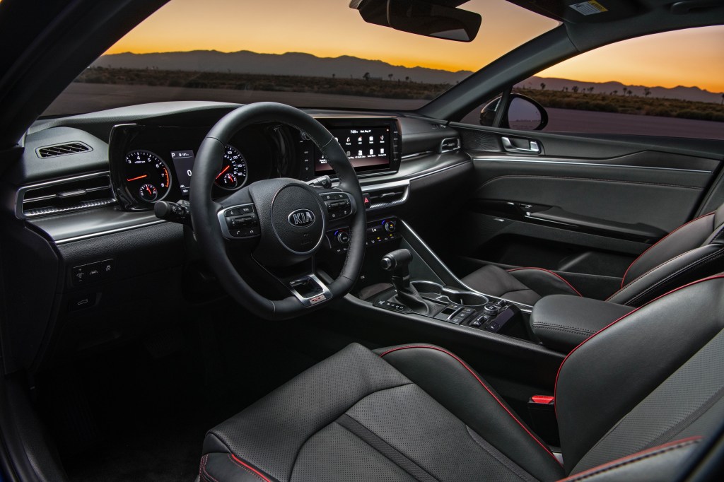 red trimmed leather interior of a 2021 Kia K5. The new k5 sedan is praised for its quiet cabin. 