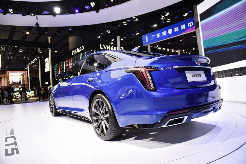 A blue Cadillac CT5 on display at an auto show