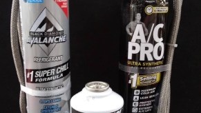 Car A/C recharge kits in canister form, with a can of R134a refrigerant