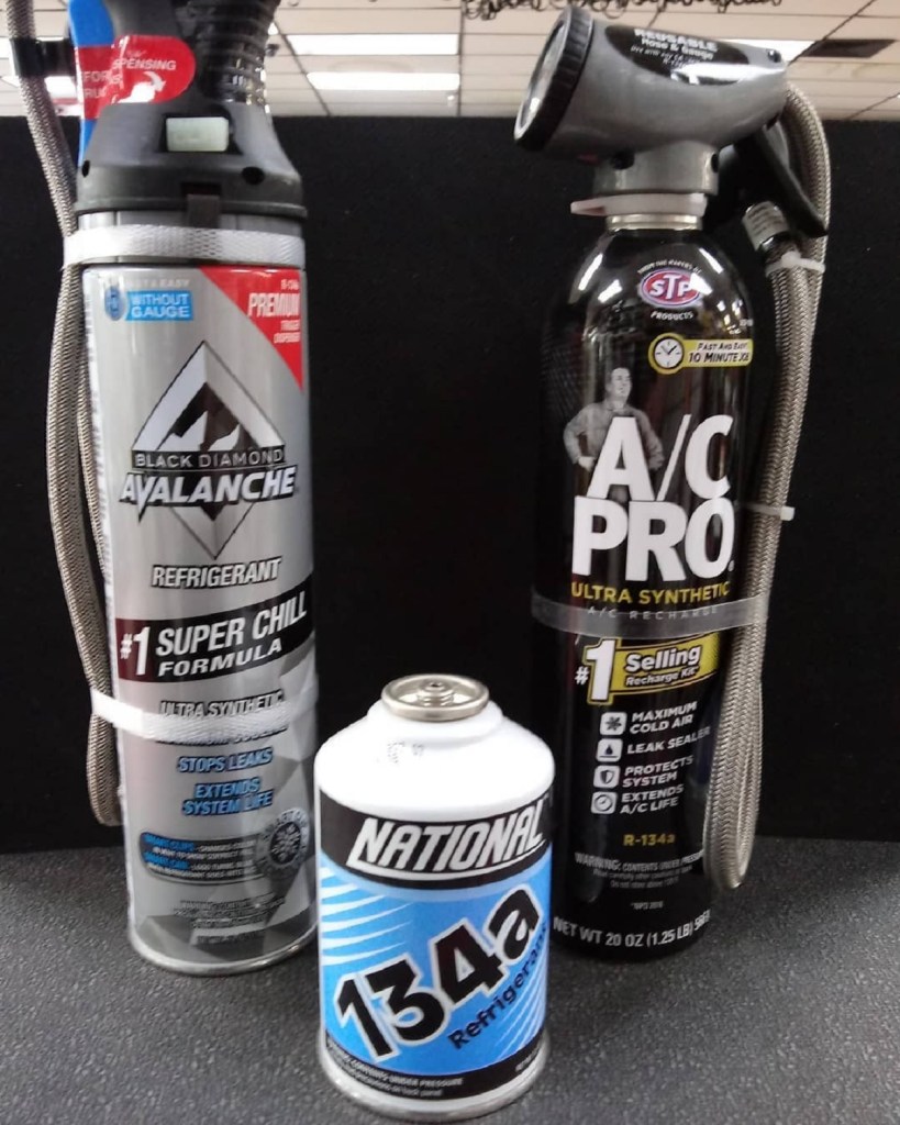 Car A/C recharge kits in canister form, with a can of R134a refrigerant