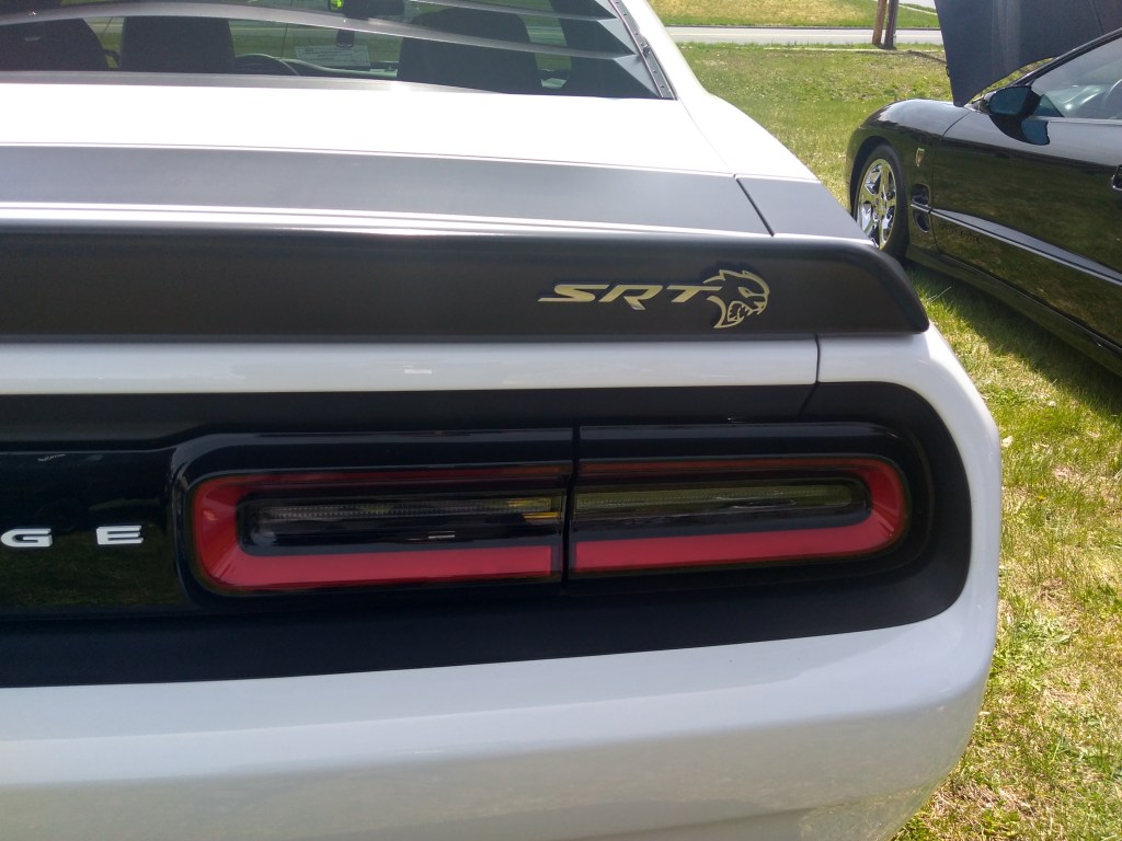 The rear of a white Dodge Challenger Hellcat