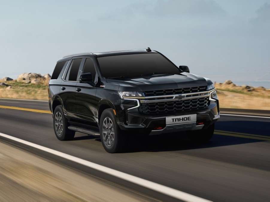 A black 2023 Chevy Tahoe driving down the road