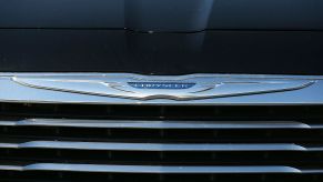 The Chrysler logo is displayed on the front of a brand new car