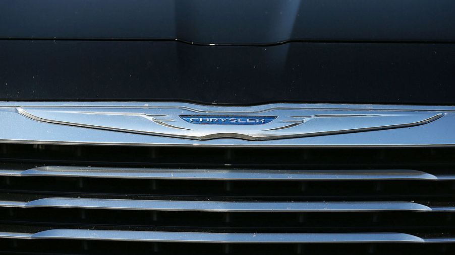 The Chrysler logo is displayed on the front of a brand new car