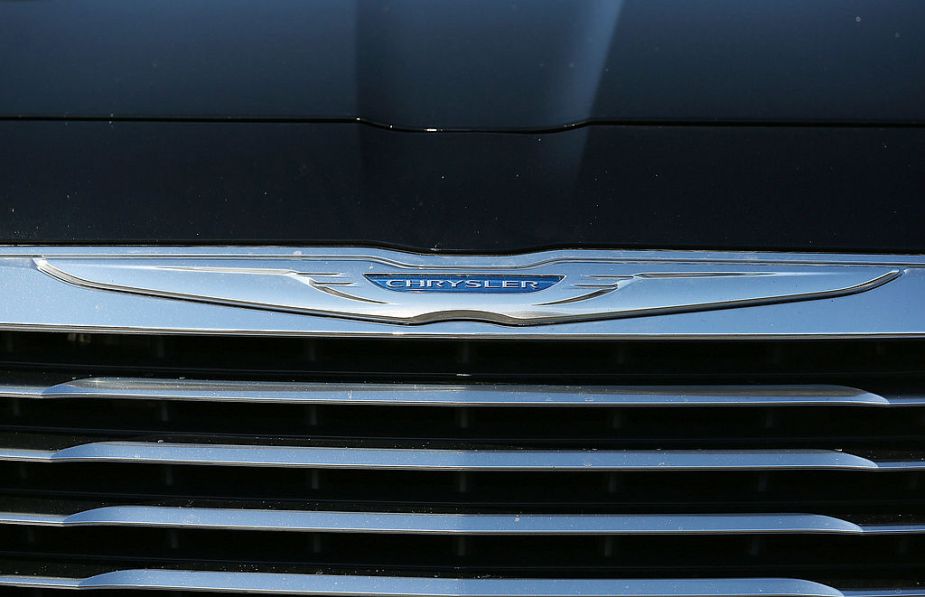 The Chrysler logo is displayed on the front of a brand new car