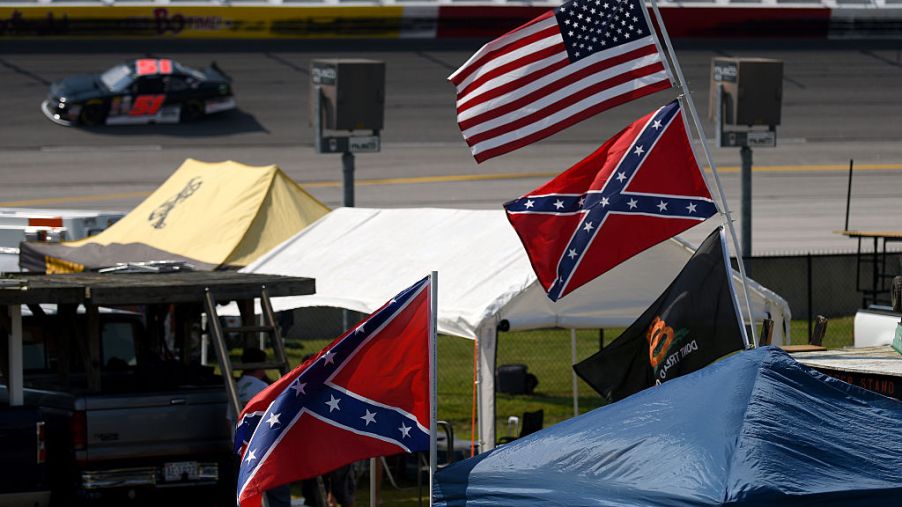 Confederate flags flying with American flags inside of NASCAR track