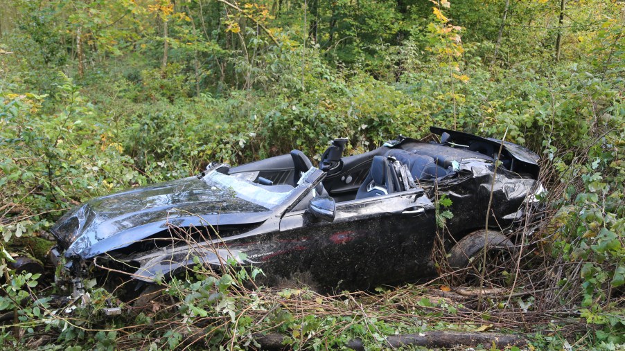 A convertible after a roll-over crash sitting in a field