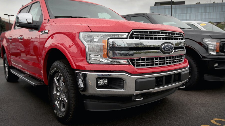 A red Ford F-150 pickup truck offered for sale at a dealership.