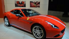 A red Ferrari California T sits on display at a car show