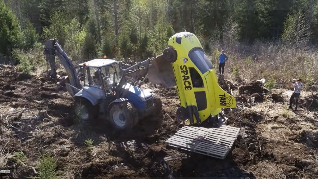 Beyond the Press Youtube channel used a tractor to load a yellow car onto a makeshift launchpad.