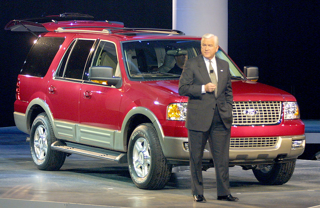 A man introducing a 2003 Ford Expedition on stage