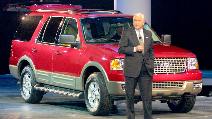 A man introducing a 2003 Ford Expedition on stage