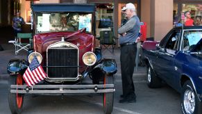A man looking at a Ford Model T on display