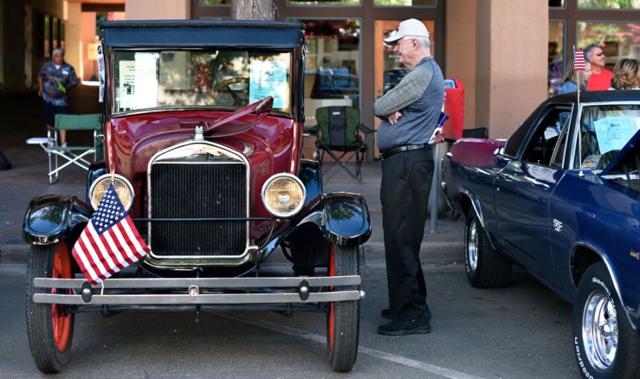 A man looking at a Ford Model T on display
