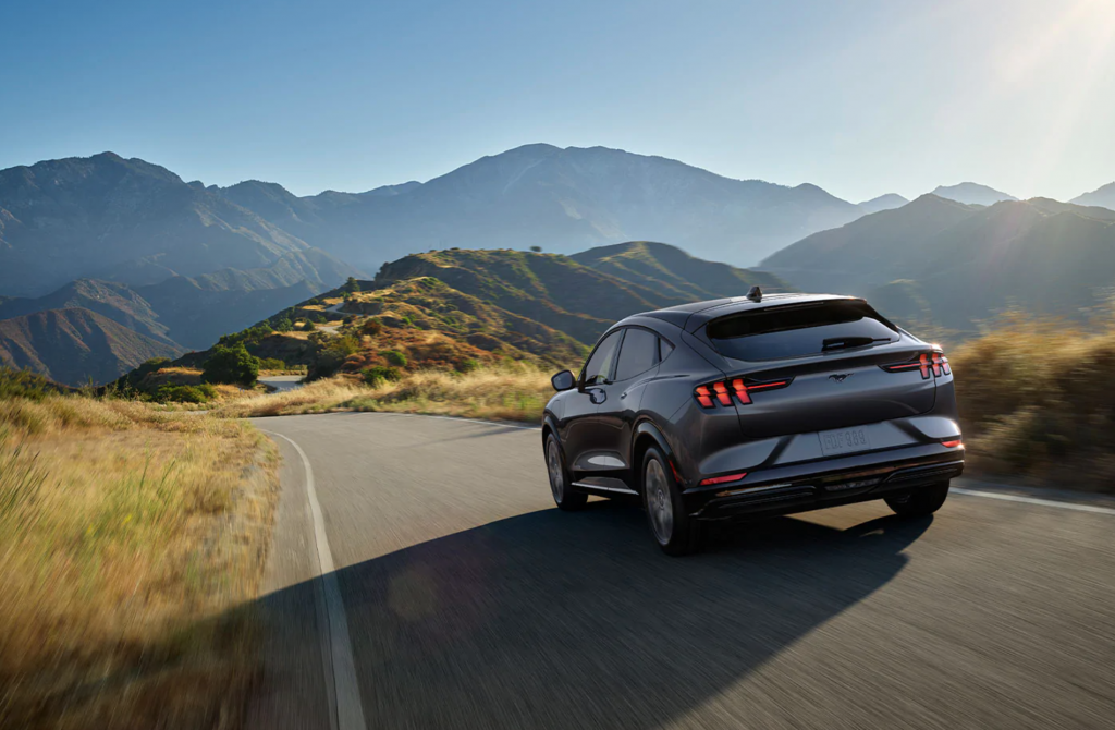 Ford Mustang Mach-E driving down mountain road 