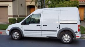 A Ford Transit work van parked outside a house.